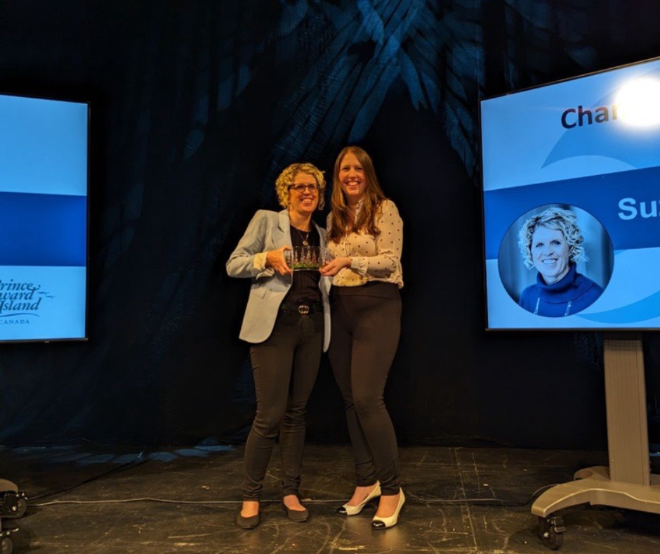 Suzanne stands on stage to accept her award from Event Atlantic