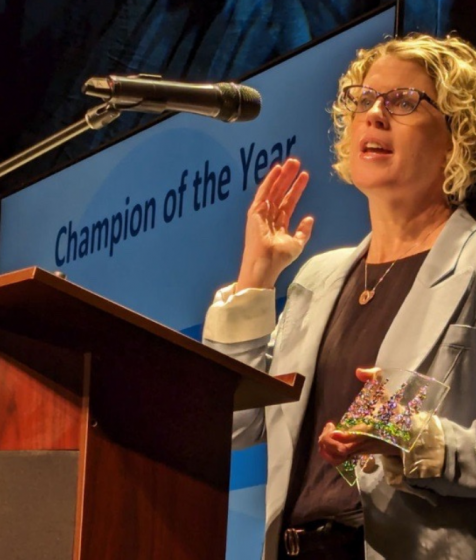Suzanne Fougere accepts the Champion of the Year award
