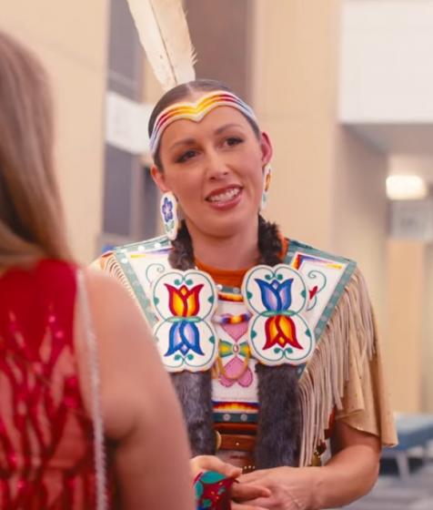 An Indigenous dancer talks to guests at the Halifax Convention Centre