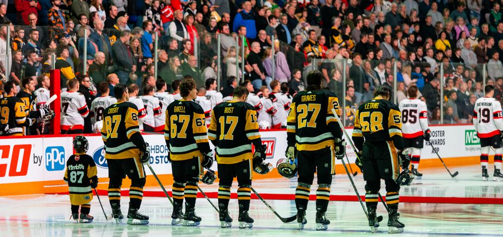 The Pittsburgh Penguins lineup on the ice for the game opening ceremony