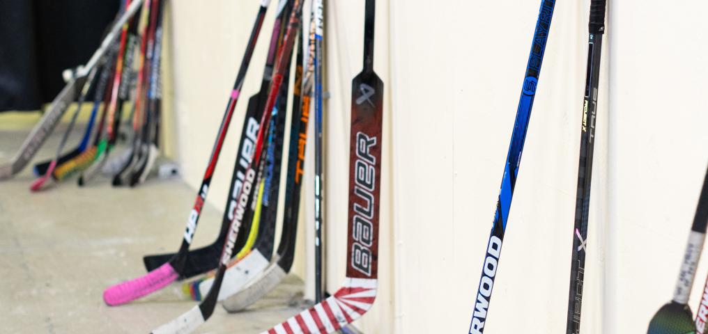 Hockey sticks against a wall 