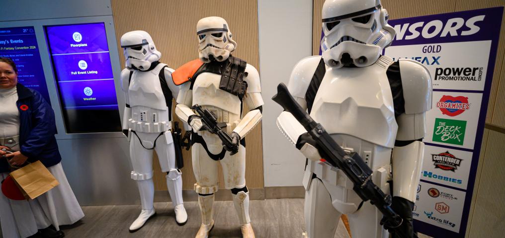 Three Storm Troopers pose with their weaponry in the lobby