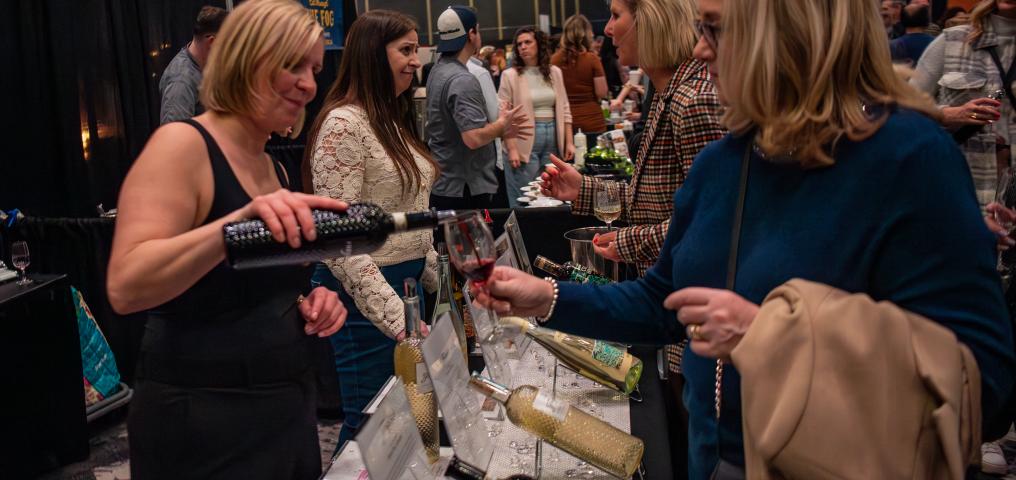 A wine seller pours a glass of wine 