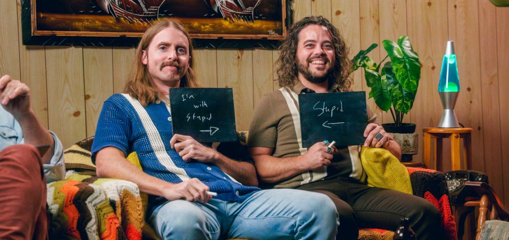 Shamus holds sign reading I'm with Stupid next to Ricky, holding sign that says Stupid (photo by Mat Dunlap)