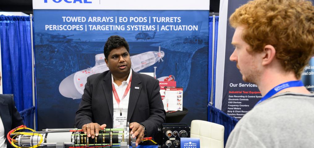 A delegate demonstrates devices at an exhibition booth